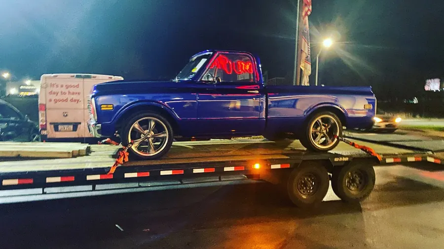 Custom Chevy C10 pickup loaded at night