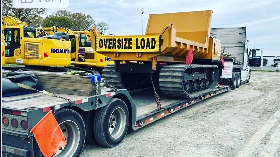 Oversized permit load with Komatsu equipment on a lowboy