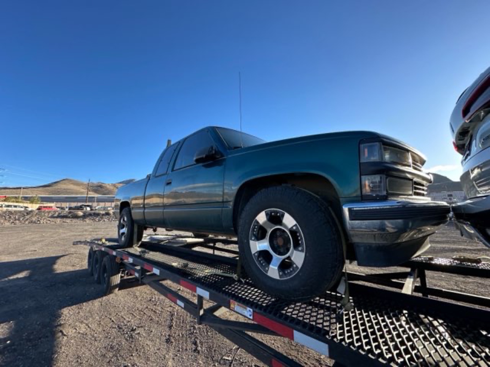 Chevy pickup loaded on an open car hauler
